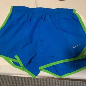 Nike dark blue shorts with green and white sides